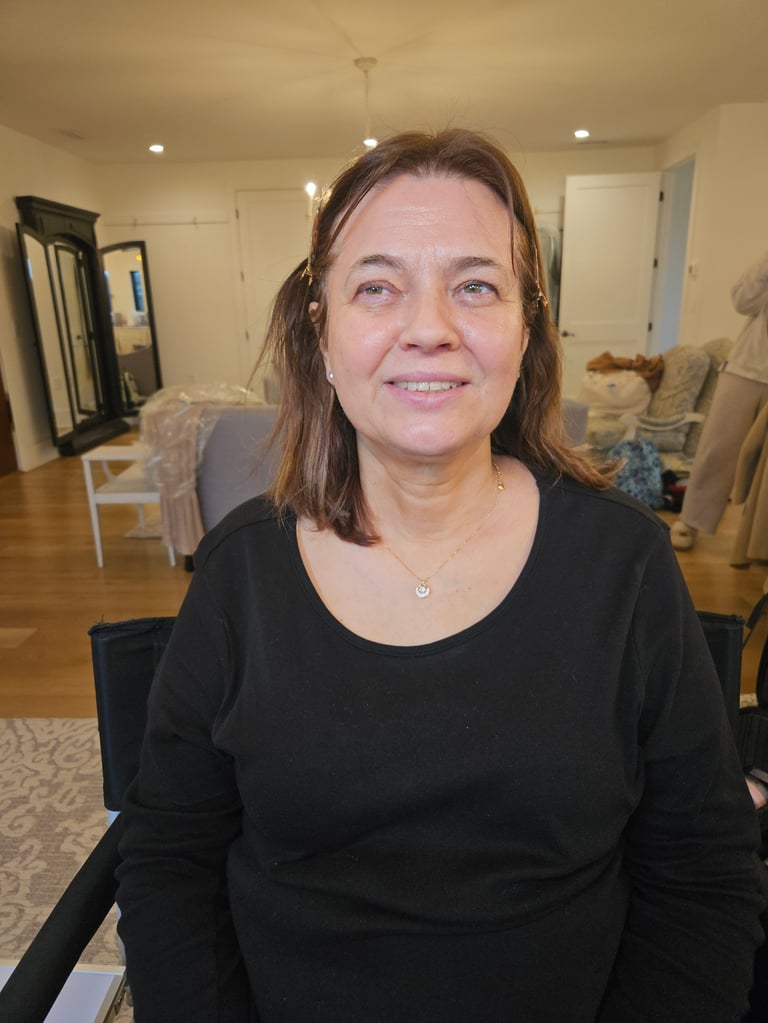 Pro-Age transformation before - woman with shoulder-length brown hair wearing a black long-sleeved shirt smiling at camera